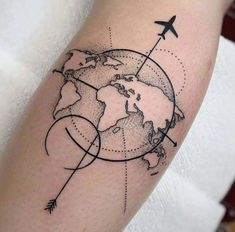 an airplane flying over the earth tattoo on the arm