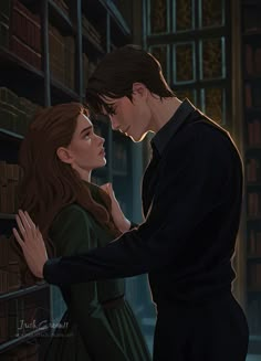 a man and woman standing next to each other in front of a bookshelf