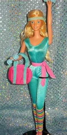 a barbie doll holding a pink purse