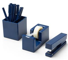 two blue office supplies with one roll of toilet paper and the other in a holder