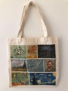 a tote bag with many paintings on it hanging from the side of a wall