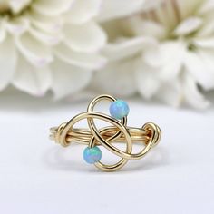 A unique ring with a blue touch just for you! Handmade with love, set with genuine blue Opal stones ☆ WHY THIS PIECE OF J E W E L R Y IS AWESOME! ☆ * Hand finished and made from high quality raw materials * Long lasting beauty & Timeless design * Available in Gold, Rose Gold or Sterling Silver ♡ WRAPPING ♡ * All 23 Summers jewels arrive in a cute pouch or gift box so they are gift ready. DELIVERY ✉ * Most items are ready made but some are made to order, Times for each items are shown on * Well p Wire Wrapped Turquoise, Wire Jewelry Rings, Wrapped Rings, Bijoux Fil Aluminium, Ring Wire, Wire Jewelry Tutorial, Ring Opal, Wire Wrapped Ring, How To Make Rings