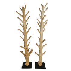 two tall wooden trees on black bases