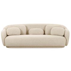 a white couch with three pillows on it's back and one arm facing the camera