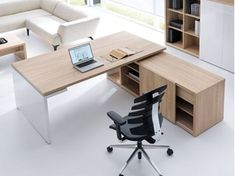 an office desk with a laptop computer on it and a chair in front of it