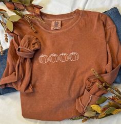 Fall Pumpkin Burnt Orange Comfort Colors Long Sleeve Shirt Welcome autumn with cozy style in our Fall Pumpkin Burnt Orange Comfort Colors Long Sleeve Shirt. Designed for both comfort and seasonal flair, this shirt is perfect for crisp fall days, pumpkin patch adventures, and festive gatherings. Key Features: Festive Design: Features a delightful pumpkin graphic with intricate autumn details, capturing the essence of fall. The design adds a touch of whimsy and seasonal charm, making it a must-hav Fall Risk Shirt, Casual Brown T-shirt For Fall, Comfortable Long Sleeve Brown Top, Comfortable Brown Tops For Fall, Trendy Brown Tops For Fall, Comfortable Brown Cotton Tops, Fall Long Sleeve Relaxed Fit T-shirt, Brown Long Sleeve Cotton T-shirt, Brown Crew Neck Top For Fall