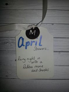 a sign that is hanging on the side of a wooden wall saying,'march showers rainy night in a redbox movie and snacks '