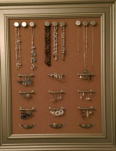 there is a framed display with jewelry on it