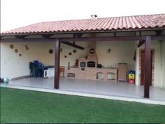 an outdoor kitchen is built into the side of a house with brick and tile roof