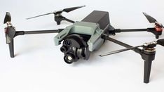 an image of a remote controlled quadcopter with camera attached to the side