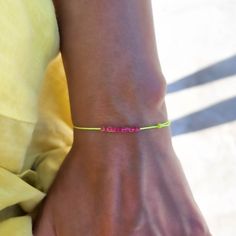 "Mens Neon Yellow String With Fuchsia Beads Bracelet Beaded Bracelet Yoga Natural Earthy Jewelry Adjustable Neon Thread Surf Vegan Unisex Surfer Bracelet Minimalist Traveler Gift - perfect as a gift for a best friend or for that beach/surfer look - adjustable bracelet - waterproof - neon yellow string - 11 high quality 1.5mm japonese fuchsia cube beads *Listing is for one bracelet. Particle's signature bracelets make perfect gift ideas. Each bracelet is mounted on a Particle card and packaged ready for gift giving. If you have any questions about this string bracelet, just hit the \"Ask a Question\" button next to the price and we will get back to you within 24 hours. SHIPPING Please view our shipping information under Policy (below) ✻ Follow us on INSTAGRAM: @particlebracelets ✻ Follow us Surfer Look, Surf Bracelet, Neon Bracelets, Surf Jewelry, Signature Bracelet, Earthy Jewelry, Surfer Bracelets, Bracelet Minimalist, Cube Beads