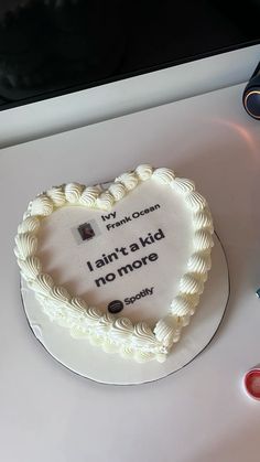 a heart shaped cake on a table with writing and scissors next to it that says, i don't speak no more