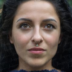 a close up of a person with a nose ring