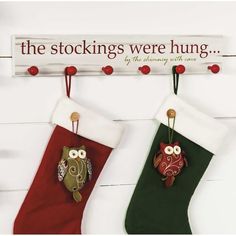 two christmas stockings hanging on the wall with an owl and owl brooch pin attached to them