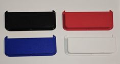 four different colored plastic cases on a white surface