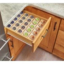 an open drawer in a kitchen filled with cupcakes