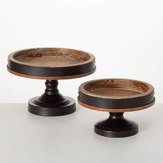 two wooden plates sitting on top of each other