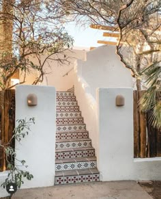 an outdoor staircase with tiled steps leading up to the house