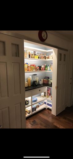 an open pantry door with food in it and shelves full of items on the other side