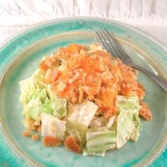 a green plate topped with salad and a fork