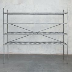 a metal shelf sitting on top of a cement floor