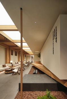 the interior of a modern house with wood and stone flooring, white walls and ceiling