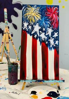 an easel with paint and fireworks on it