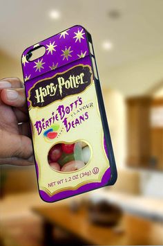 a person holding up a harry potter phone case with jelly beans in the front and back