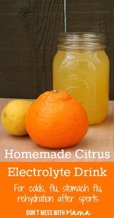 an orange and lemon sitting next to a jar of liquid on top of a wooden table