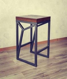 a small wooden table sitting on top of a hard wood floor