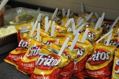 bags of potato chips sitting on top of a counter