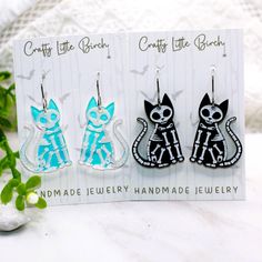 Introducing our Skeleton Cat and Bat Dangle Earrings, perfect for adding a touch of spooky charm to your Halloween ensemble. Each pair is crafted from high-quality engraved acrylic, ensuring durability and a unique look. The earrings are finished with 304 stainless steel hooks, making them safe for sensitive ears. - Bat earrings measure 1.45 inches wide and 1.7 inches long - Cat earrings measure 1.25 inches wide and 1.6 inches long - Available in black and white or iridescent color options Color Skeleton Cat, Cat Skeleton, Long Cat, Engraved Acrylic, Iridescent Color, Bat Earrings, Skeleton Halloween, Halloween Earrings, Cat Earrings