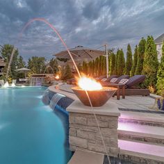 an outdoor fire pit next to a swimming pool