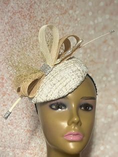 Cream Button Fascinator Half Hat for Church Head Covering, Tea Party, Wedding, and Other Special Occasions This cream circular hat is trimmed with veil and sinamay bows. Beautiful show-stopper! Mannequin is wearing size 6 inches. Available in 3 sizes  6 inches diameter 7 inches  8 inches  Hat affixes to head by hat string. Handmade gifts for mom, sister, wife, or yourself. Love what you see, but would like it in a different color, shape or size? Please contact us by sending a message. We offer custom hats in a variety of styles. PLEASE NOTE All items for Free Shipping will be shipped via USPS First Class Mail. Elegant Fitted Bridal Accessories For Party, Adjustable Gatsby Style Fascinator For Vintage Events, Party Bridal Hat Accessories, Elegant Headband Fascinator For Ceremony, Elegant Church Hats With Pinched Crown, Gatsby Style Mini Hat With Short Brim For Parties, Beige Curved Brim Fascinator For Formal Events, Fitted Gold Fascinator With Curved Brim, Adjustable Cream Fascinator With Short Brim