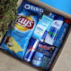 a box filled with lots of different types of snacks and condiments on top of a table