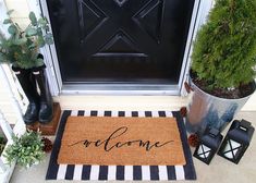 a welcome mat with the word welcome on it in front of a black and white door