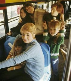 a group of people riding on the back of a bus