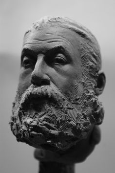 a black and white photo of a man's head with a beard on it