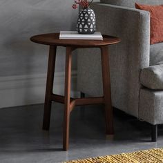 a living room with a couch, chair and small table in front of the sofa