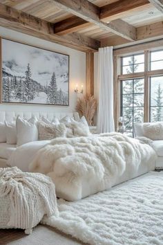 a large white bed sitting in a bedroom next to a window with snow on it