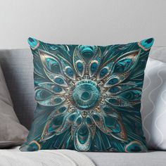 a blue and gold throw pillow sitting on top of a couch