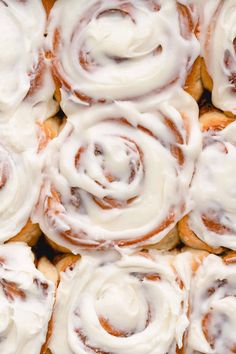 there are many cinnamon rolls with icing on them