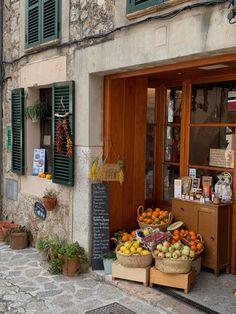 an outdoor fruit stand on the side of a building