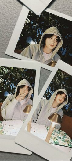 four polaroid photos of a person wearing a hood and holding a lamp in front of them