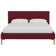 a bed with white sheets and red headboard