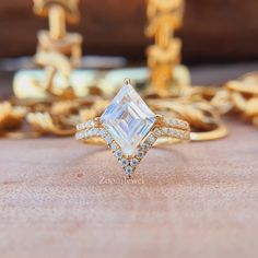 a diamond ring sitting on top of a table next to gold chains and other jewelry