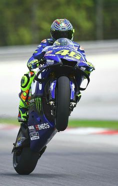 a person riding a motorcycle on a race track