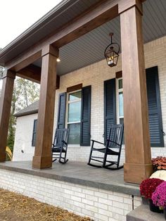 two rocking chairs on the front porch of a house