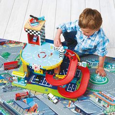 a young boy playing with a toy train set