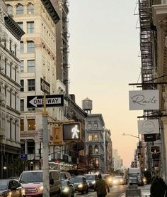 a city street filled with lots of traffic and tall buildings next to eachother